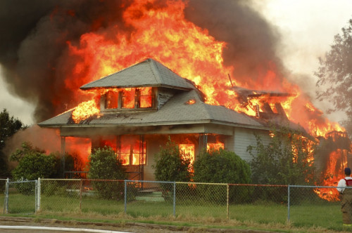 Image of house on fire, ICON Restoration and Construction can help.